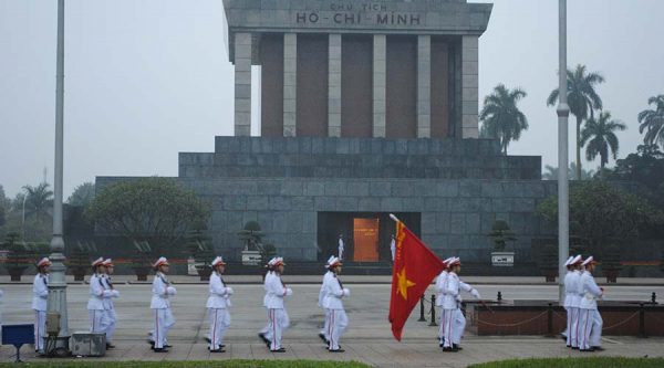 flag rising at Ho Chi Minh Mausoleum in Hanoi